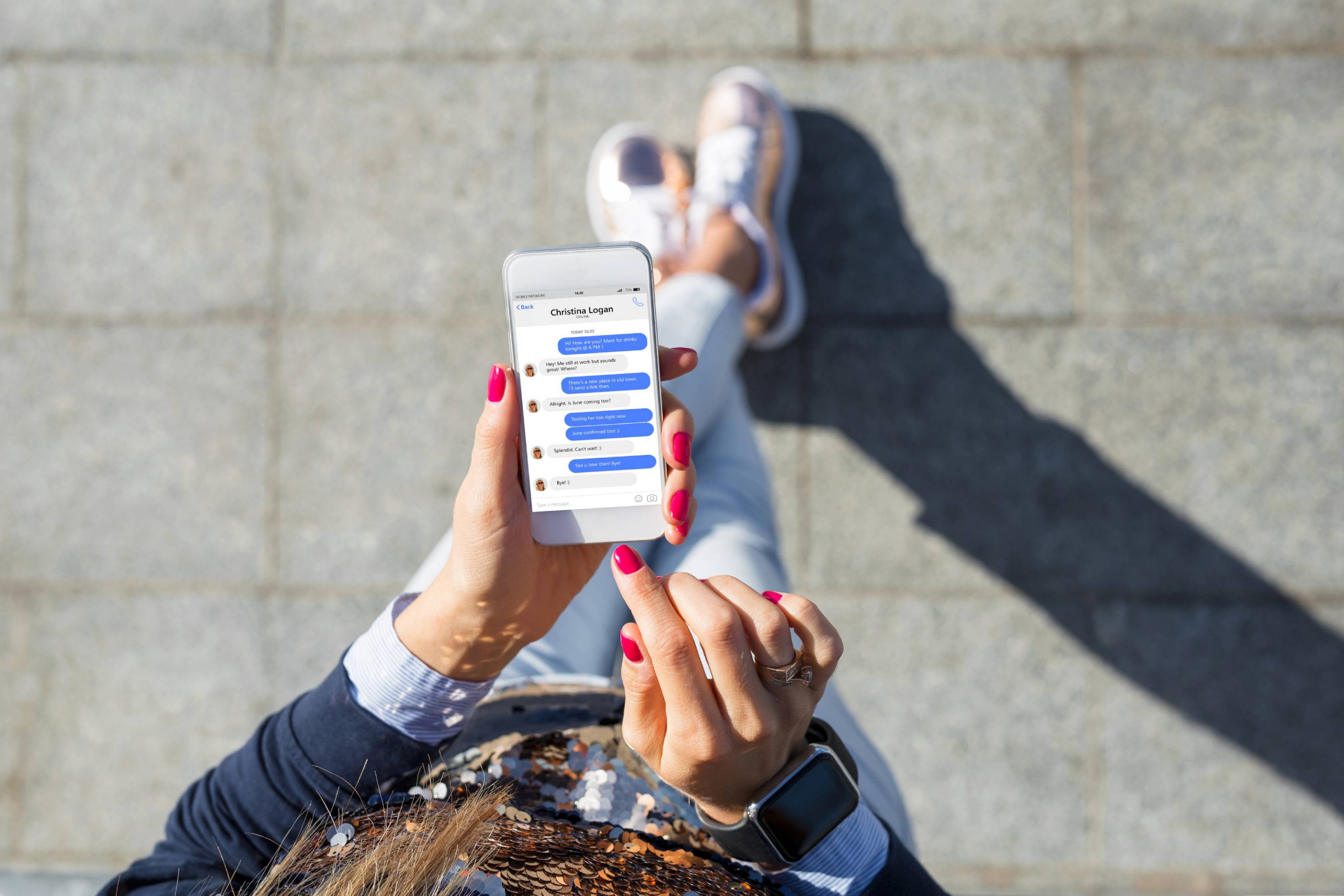 Woman using instant messaging app on mobile phone, view from above.