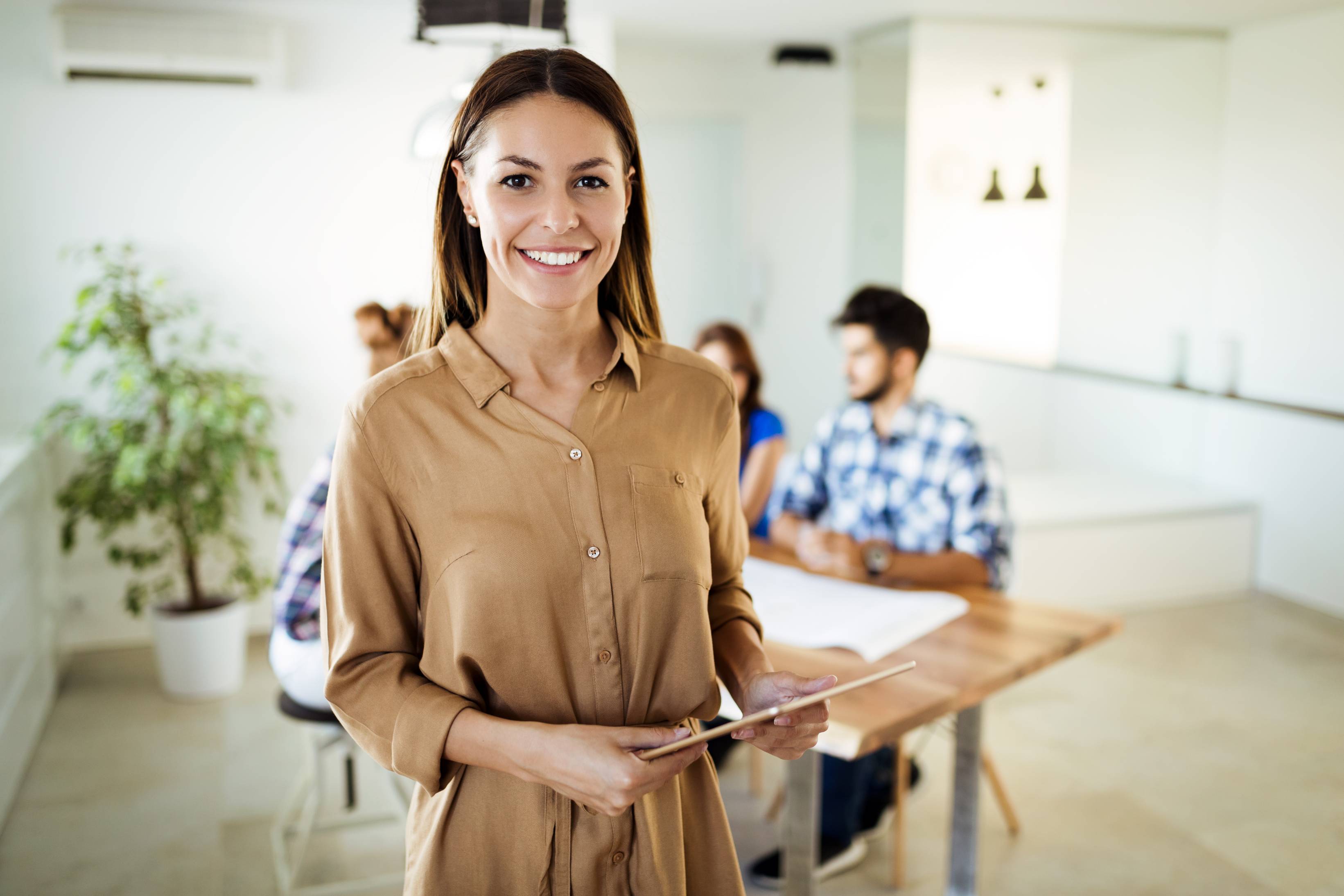 Businesswoman holding tablet at conference tablet having company meeting.