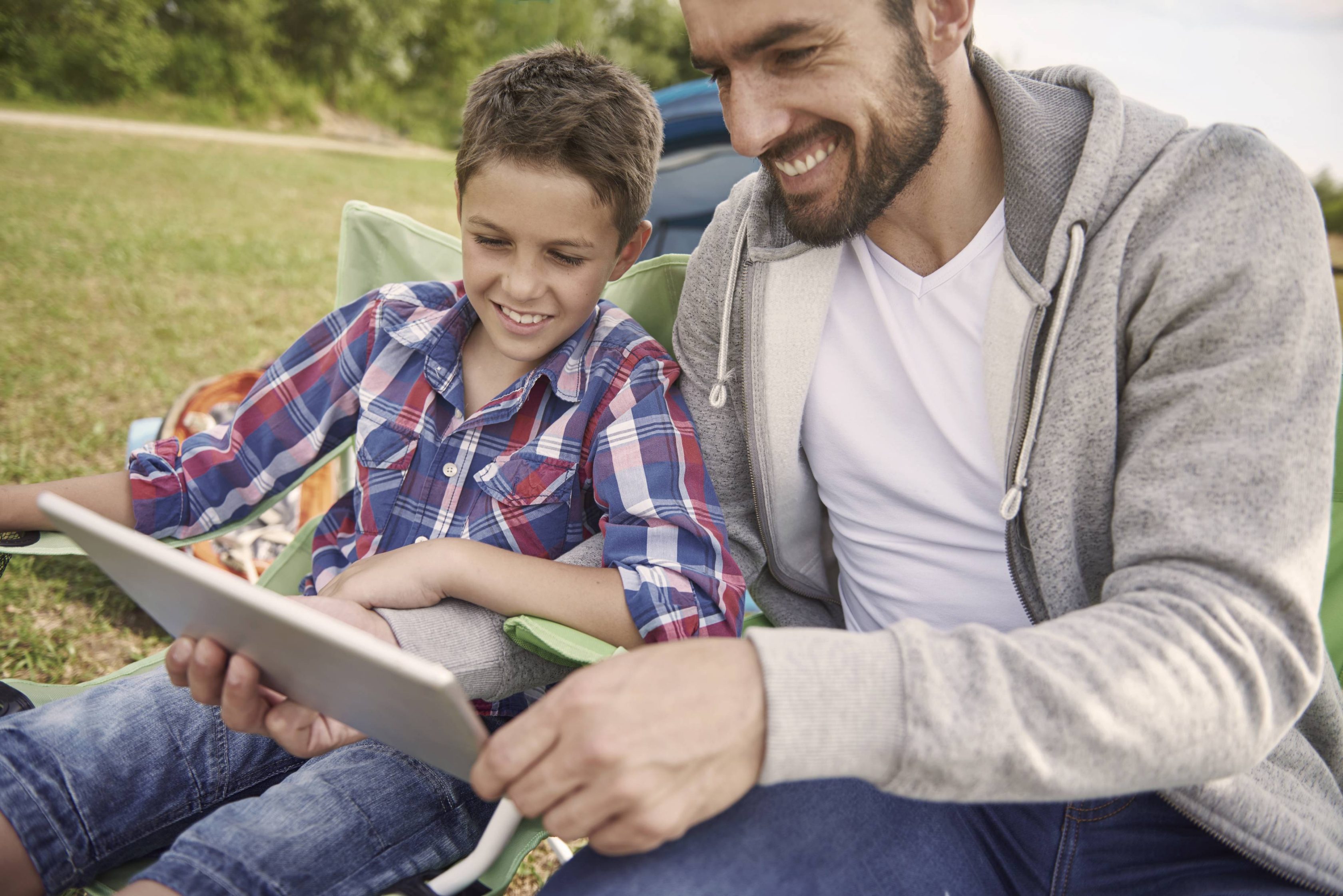 Happy father and son using a tablet